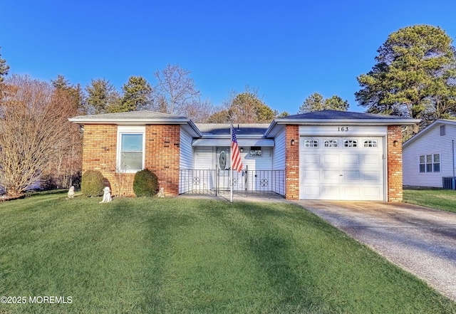 ranch-style house featuring central air condition unit, a front yard, and a garage