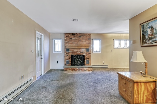 unfurnished living room featuring carpet flooring, a baseboard heating unit, a fireplace, and a healthy amount of sunlight