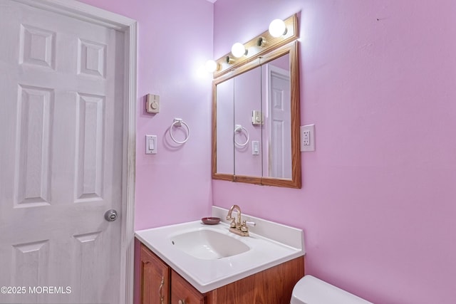 bathroom featuring vanity and toilet