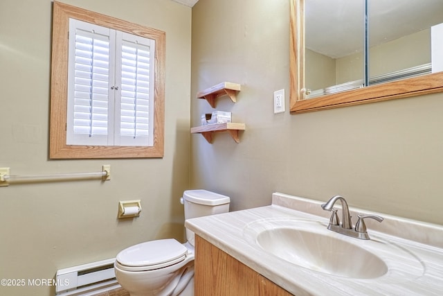 bathroom featuring toilet, a baseboard heating unit, and vanity