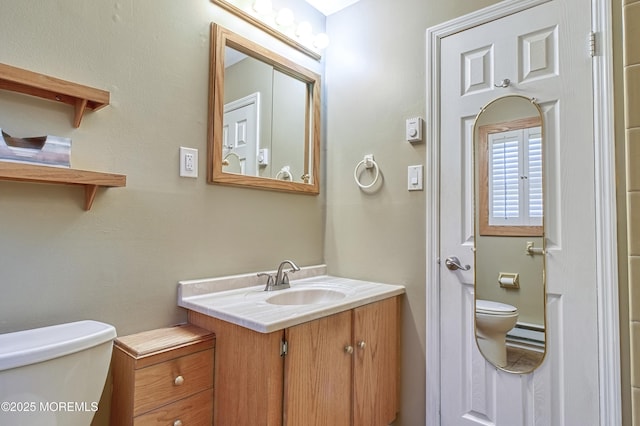 bathroom with toilet and vanity