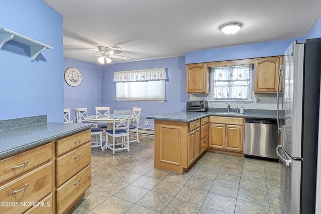 kitchen featuring stainless steel appliances, sink, ceiling fan, tasteful backsplash, and kitchen peninsula