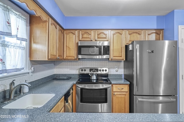 kitchen featuring sink, backsplash, and appliances with stainless steel finishes