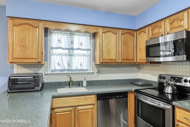 kitchen featuring sink, stainless steel appliances, and backsplash