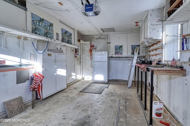 interior space featuring white cabinetry and white fridge