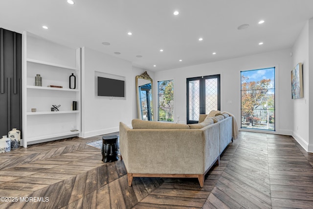 living room featuring french doors and dark parquet flooring