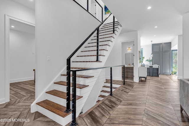 staircase featuring parquet floors