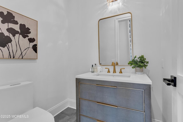 bathroom featuring toilet and vanity