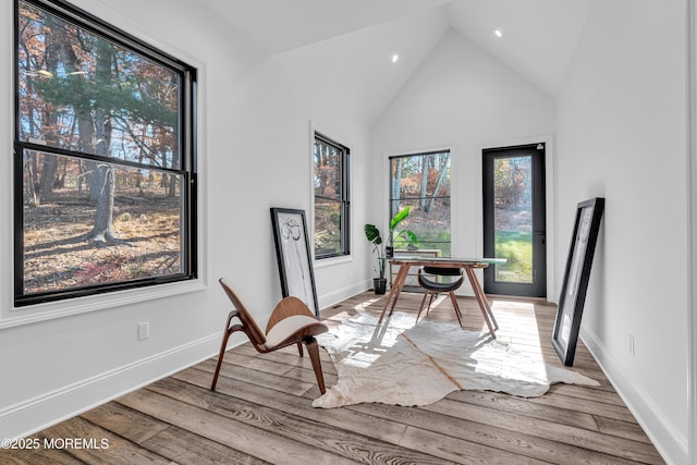 office space with vaulted ceiling and light hardwood / wood-style flooring