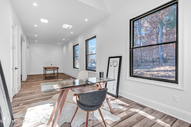 office space featuring light wood-type flooring and lofted ceiling