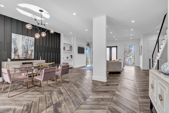 dining space with built in features and parquet floors