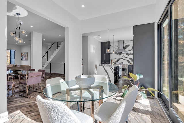 dining room featuring light wood-type flooring and a notable chandelier