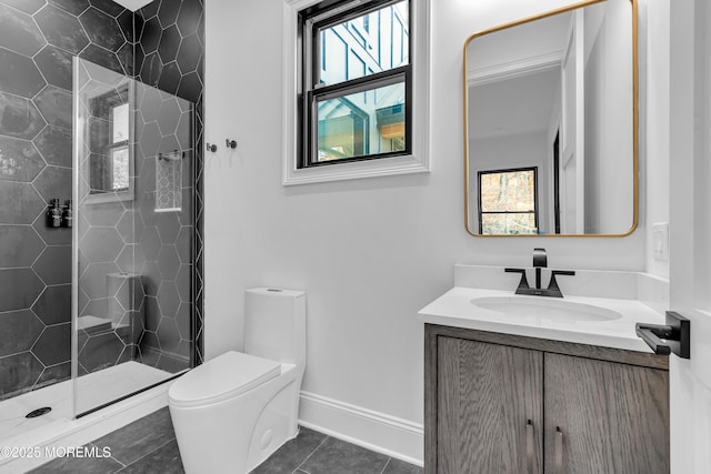 bathroom with toilet, vanity, tile patterned flooring, and plenty of natural light