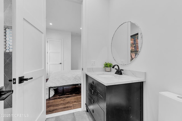 bathroom featuring toilet, vanity, and tile patterned flooring