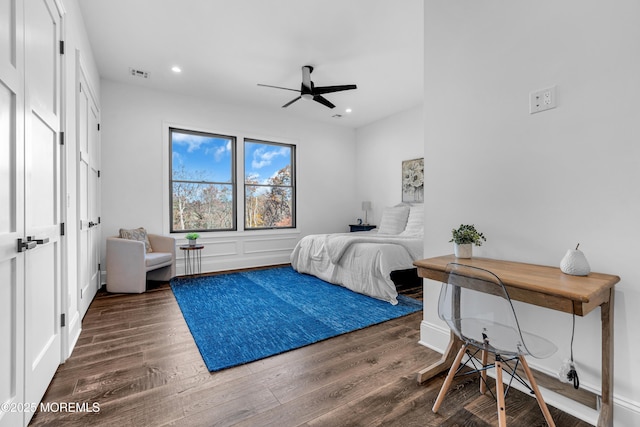 bedroom with ceiling fan and dark hardwood / wood-style floors