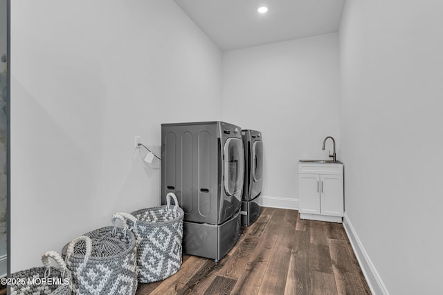 clothes washing area featuring cabinets, sink, independent washer and dryer, and dark wood-type flooring