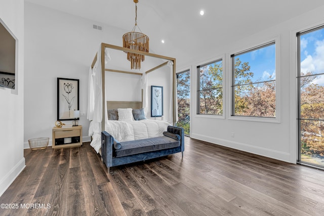 bedroom featuring dark wood-type flooring and a chandelier