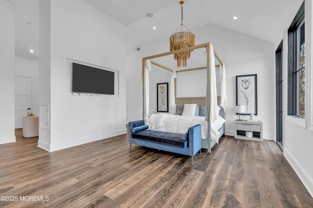 bedroom featuring vaulted ceiling, dark wood-type flooring, and a chandelier