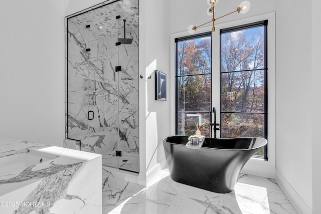 bathroom featuring an inviting chandelier and plus walk in shower