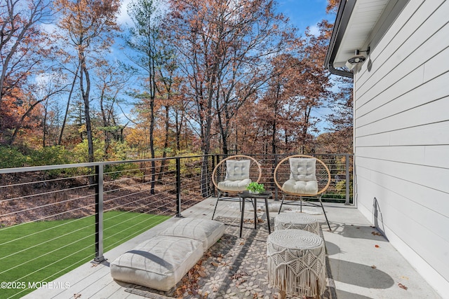 wooden terrace with a lawn