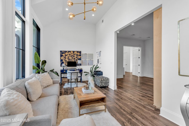 living room with a chandelier, hardwood / wood-style floors, and high vaulted ceiling