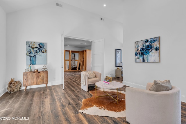 sitting room featuring high vaulted ceiling and dark hardwood / wood-style flooring