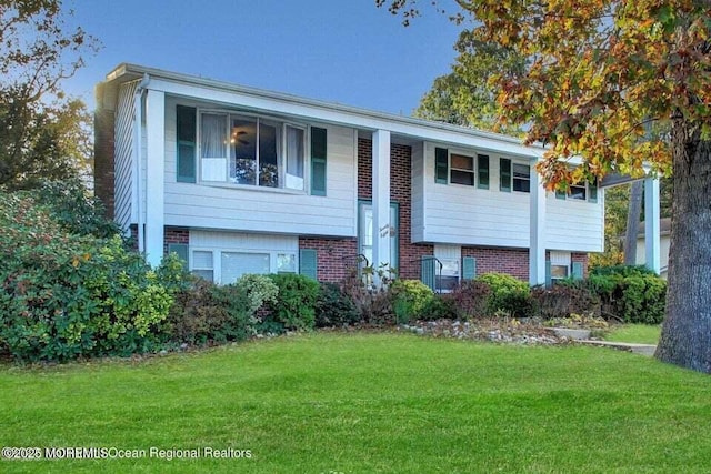 split foyer home with a front lawn