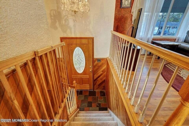 staircase featuring a notable chandelier