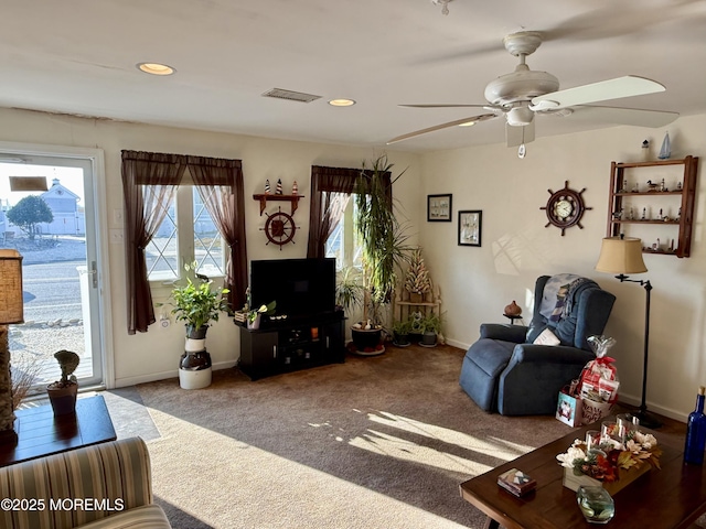 living room featuring ceiling fan and carpet