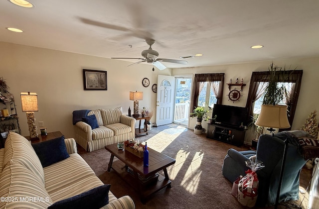 carpeted living room featuring ceiling fan