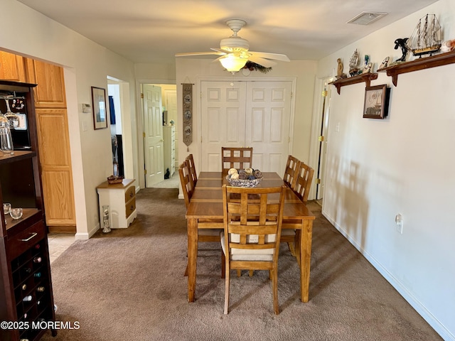 carpeted dining space featuring ceiling fan