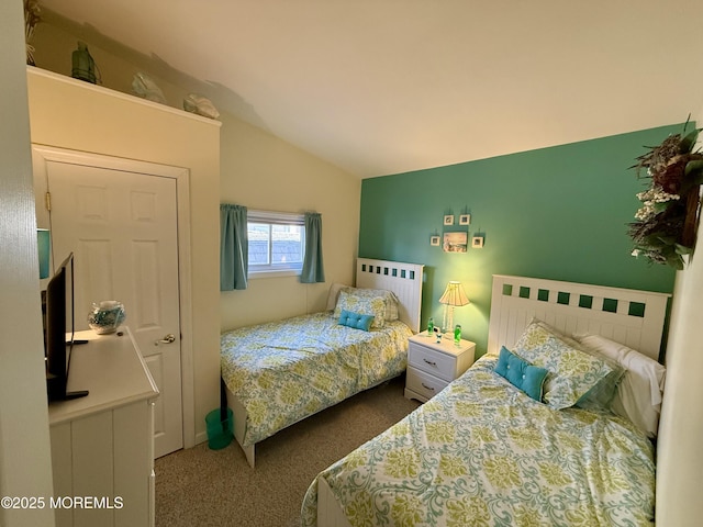 carpeted bedroom featuring lofted ceiling