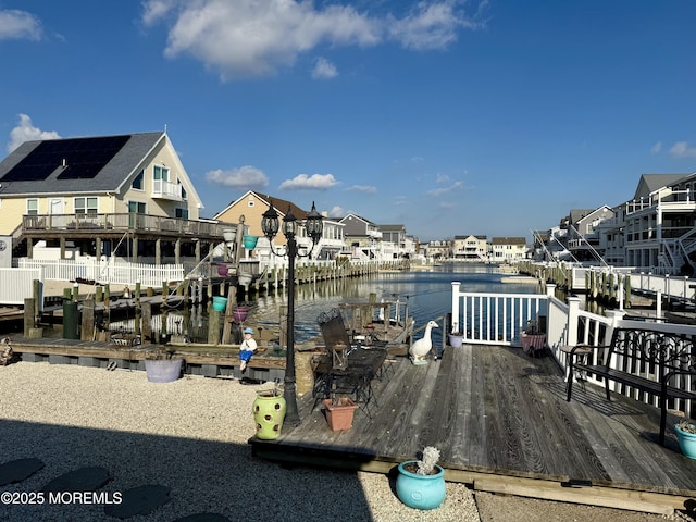 dock area featuring a deck with water view