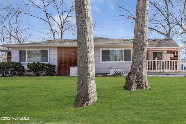 ranch-style house with covered porch and a front lawn