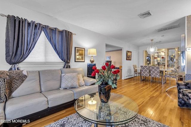 living room featuring hardwood / wood-style floors and a chandelier