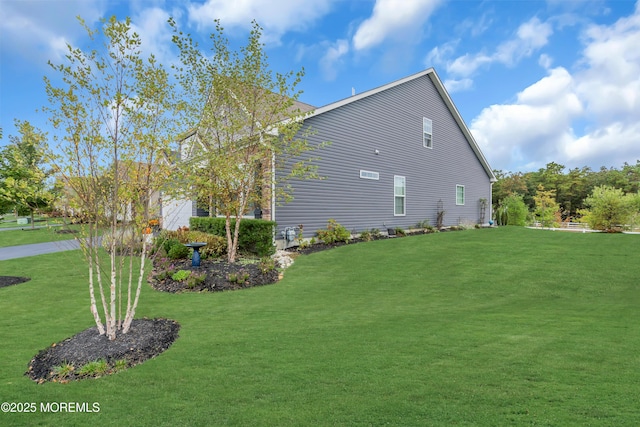 view of side of home with a lawn