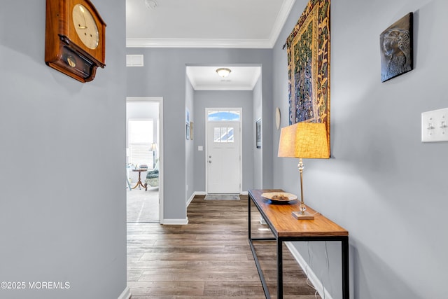 foyer entrance with dark wood-type flooring and ornamental molding