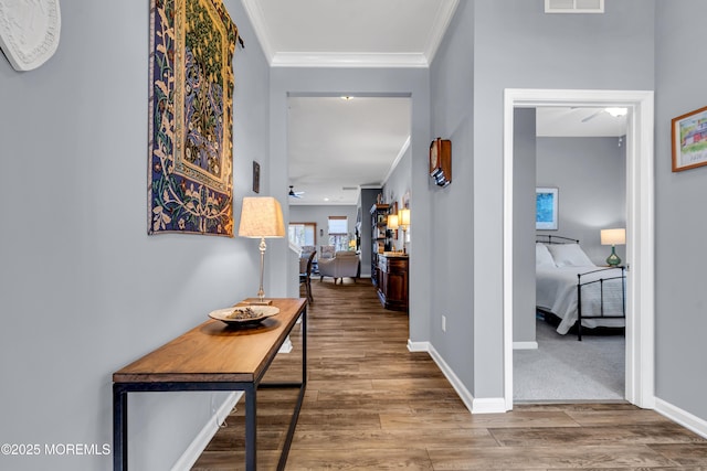 corridor featuring hardwood / wood-style floors and ornamental molding