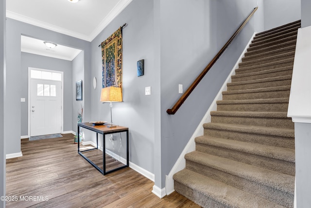 entrance foyer with wood-type flooring and ornamental molding