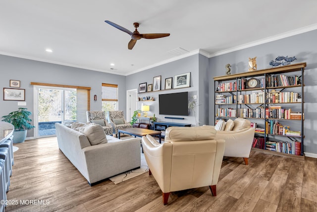 living room featuring ceiling fan, light hardwood / wood-style flooring, and ornamental molding