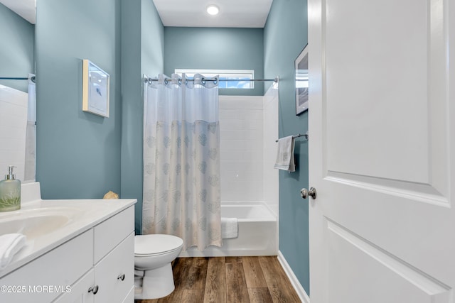 full bathroom with shower / tub combo with curtain, vanity, toilet, and hardwood / wood-style flooring