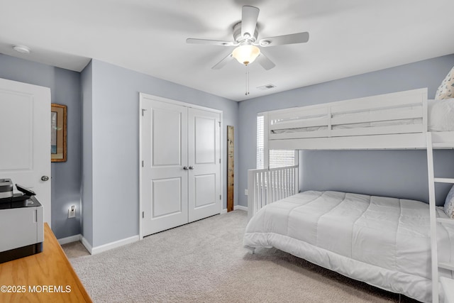 bedroom with a closet, light carpet, and ceiling fan