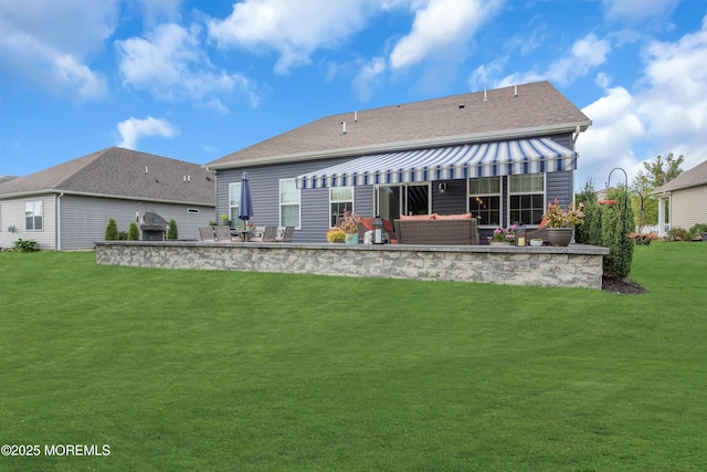 back of house with a patio and a lawn