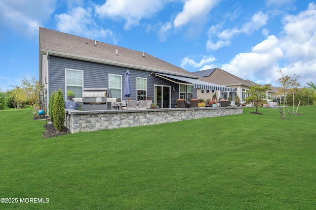 rear view of house with a lawn