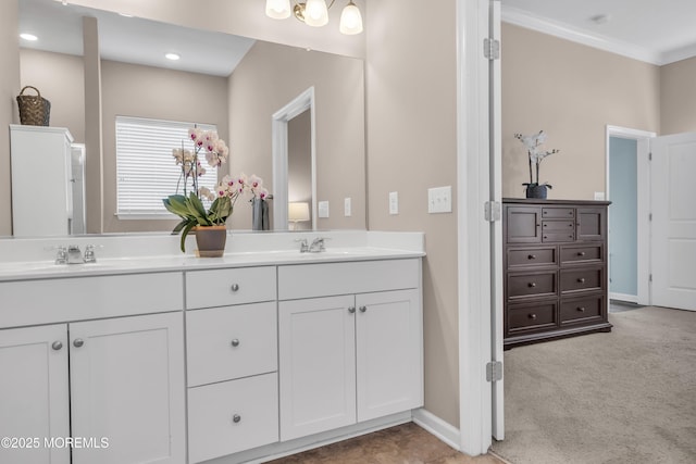 bathroom with ornamental molding and vanity