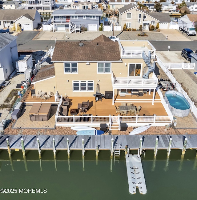 birds eye view of property with a water view and a residential view