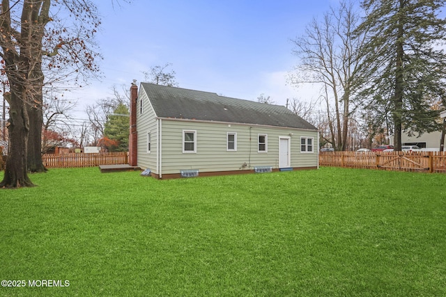 rear view of house with a lawn