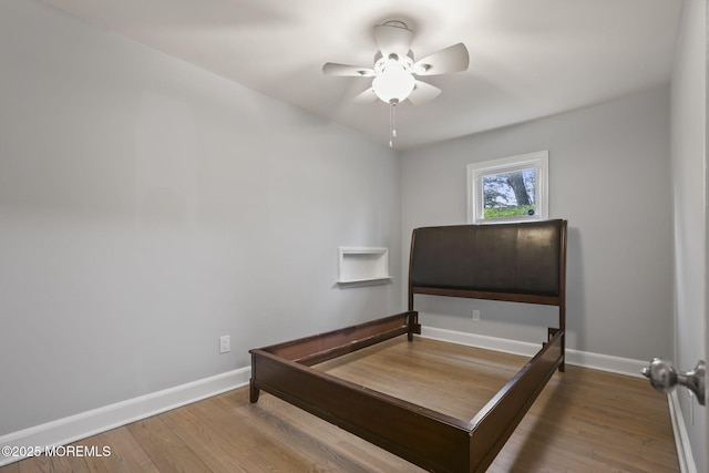 bedroom with ceiling fan and hardwood / wood-style floors