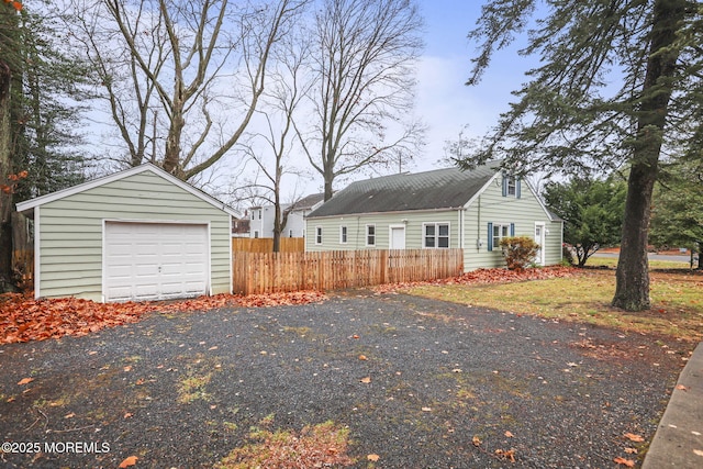 exterior space featuring a garage and an outdoor structure