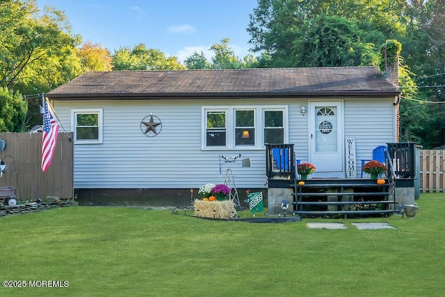 rear view of house with a yard